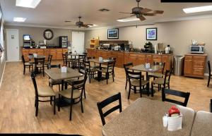 a restaurant with tables and chairs and a kitchen at Best Western of Hope in Hope