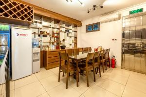 a kitchen with a table and chairs and a refrigerator at Westlake Tay Ho Hotel 696 Lạc Long Quân in Hanoi