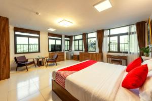 a bedroom with a large bed with red pillows at Westlake Tay Ho Hotel 696 Lạc Long Quân in Hanoi