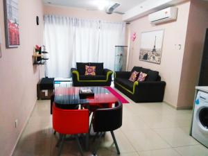 a living room with a table and a couch at i-City I-SOHO in Shah Alam