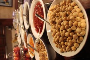 a buffet with plates of food on a table at Hotel SultanHill in Istanbul