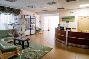 a lobby with a waiting room with chairs and a table at Belovezhskaya pushcha Hotel №2 in Kamenyuky