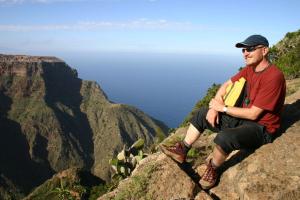 a man sitting on the edge of a mountain at Hotel Nautico in Santa Cruz de Tenerife