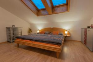 a bedroom with a large bed with a wooden headboard at Apart Georg in Kleinboden