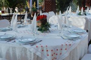 a table with white table cloth and white plates and napkins at Rive Du Lac in Lalla Takerkoust +192 photos