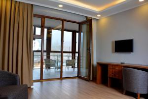 a living room with a television and a table with chairs at Sheki Park in Sheki