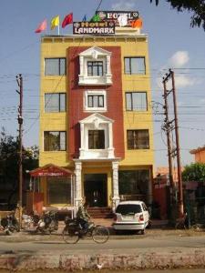 a tall building with a sign on top of it at Hotel Landmark in Haridwār