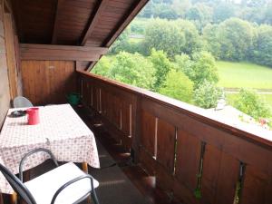 a table and chairs on a balcony with a view at Apartment Weissenegger in Völs am Schlern