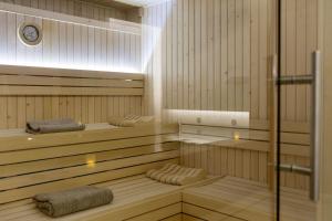 a sauna with wooden floors and a glass door at Bordoy Alcudia Port Suites in Port d'Alcudia