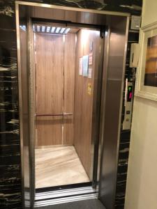a elevator with a wooden door in a room at Taroko Inn in Xincheng