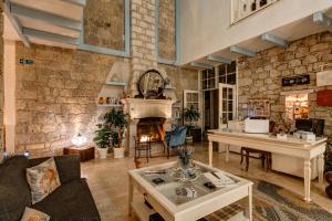 a living room with a table and a fireplace at Beyazhan Hotel in Alacati