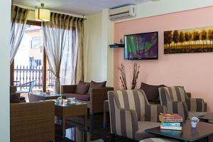 a living room with a couch and a table at Anthena Studios in Skiathos