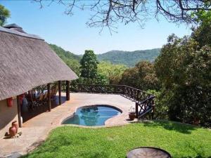 a backyard with a small pool and a bridge at Sunset Creek Game Lodge in Karino