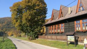 a wooden house on the side of a road at Penzión Manín in Považská Bystrica