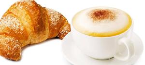 a cup of coffee and a pastry on a plate at Home 146 in Lamezia Terme