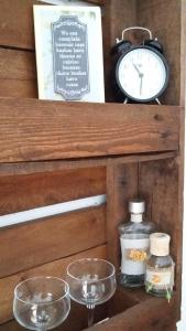 a clock and some glass bowls on a wooden shelf at Archondissa Beach Aparthotel in Therma