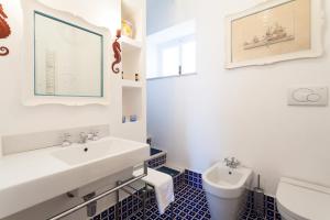 a bathroom with a sink and a toilet at Casa Bellevue in Positano +12 photos