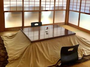 a table in a room with two chairs around it at 一棟貸し平戸よこた in Hirado