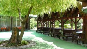 a pavilion with benches and a tree in a courtyard at Hotel Briz 3 - Free Parking in Varna City