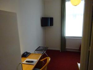 TV a/nebo společenská místnost v ubytování City Hotel Nebo