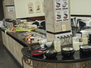 a kitchen with a counter with food on it at Bravo City Hotel Primavera in Primavera do Leste