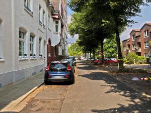 un coche aparcado al lado de una calle en Apartments Essen-Rüttenscheid, en Essen