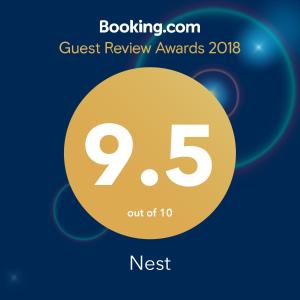 a sign that reads quest review awards with a yellow circle at Nest in Drobeta-Turnu Severin