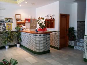 a restaurant with a counter in a room at Hotel Mirasol in Órgiva