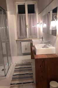 a bathroom with a sink and a shower at Cavalese Mountain Luxury Apartment in Cavalese