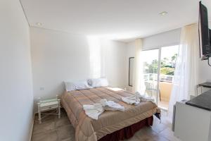 a bedroom with a bed with towels on it at Brezos Hotel & Spa in Valeria del Mar +67 photos