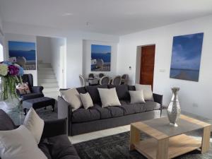 a living room with a couch and a table at Plage Residences in Paphos