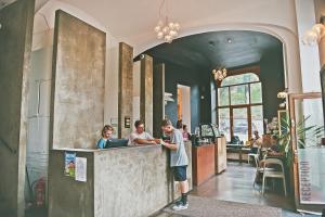 two people standing at a counter in a restaurant at Czech Inn in Prague