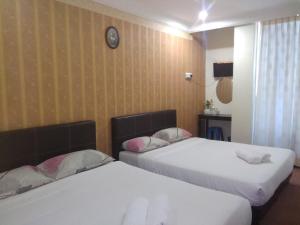 Postel nebo postele na pokoji v ubytování Hotel Tropicanna Pulai Point + 18 fotografií