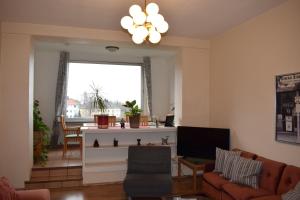 a living room with a couch and a tv at Messewohnung Augusta in Wuppertal