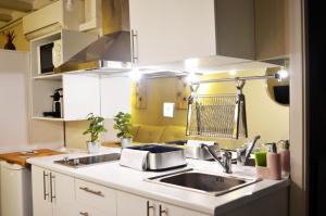 a kitchen with a sink, stove, and dishwasher at Barcelona Mercaders Apartments in Barcelona