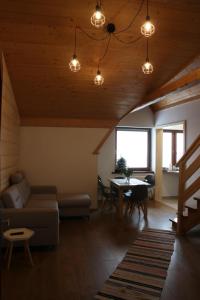 a living room with a couch and a table at Apartamenty i pokoje u Klimka in Zakopane