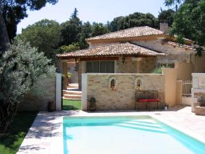 a house with a swimming pool in a yard at Villa Bacchus, Provence in Les Angles Gard