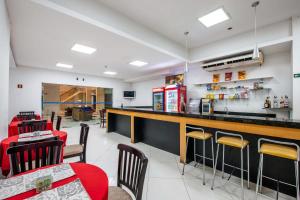 a restaurant with a bar with chairs and a table at GOLD MARTAN HOTEL in Belém +19 photos
