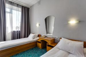 
a hotel room with a bed and a desk at Marins Park Hotel Rostov in Rostov on Don

