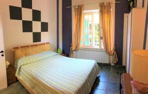 una camera con un letto con una coperta a scacchi e una finestra di Appartamento Tennis a Cannero Riviera