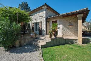 a stone house with a garden in front of it at Villa Bacchus, Provence in Les Angles Gard