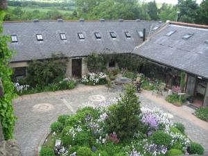 an outdoor garden with a table and chairs and flowers at Alnwick Lodge West Cawledge Park in Shilbottle