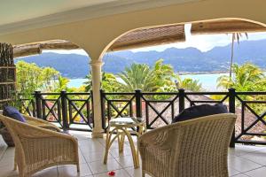 - une terrasse couverte avec des chaises et une vue sur l'océan dans l'établissement Villa De Cerf, à Île au Cerf
