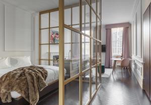 a bedroom with a bed and a desk in a room at The Moorgate by COVE in London