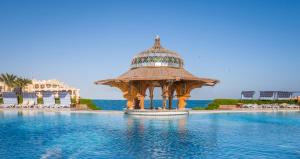 a large swimming pool with a large clock on top at Sunny Days Palma De Mirette Resort & Spa - Families and couples only in Hurghada
