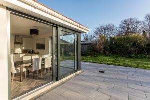 a glass extension of a house with a patio at Killester Self Catering Cottage in Dublin