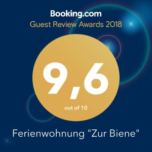 a sign that reads guest review awards featuring a yellow circle at Ferienwohnung "Zur Biene" in Winsen
