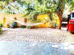 a hammock hanging from a tree in a courtyard at Kalpitiya Guest House in Kalpitiya