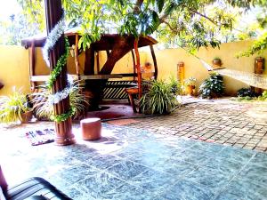 a patio with a gazebo and some plants at Kalpitiya Guest House in Kalpitiya