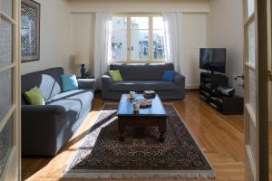 a living room with a couch and a coffee table at ACROPOLIS MUSEUM APARTMENT in Athens